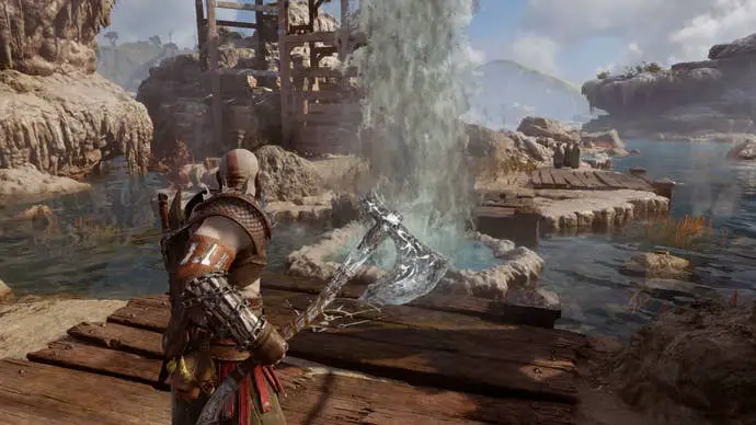 Kratos congelando géiseres en Aurvangar Wetlands con un hacha en God of War Ragnarok